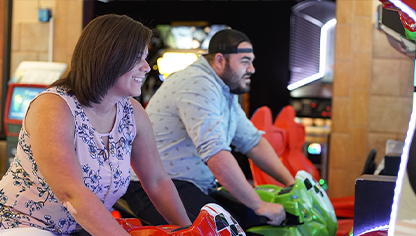 Two people playing games at arcade